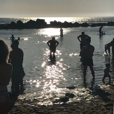 People wading in the calm water. Swimming at Ericeira beaches is a must!