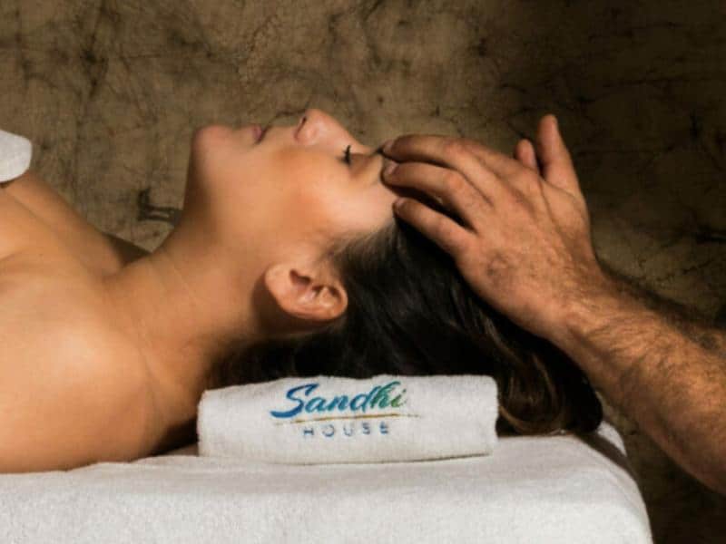 Woman getting a head massage. Sandhi house offers some of the best massages in Ericeira.