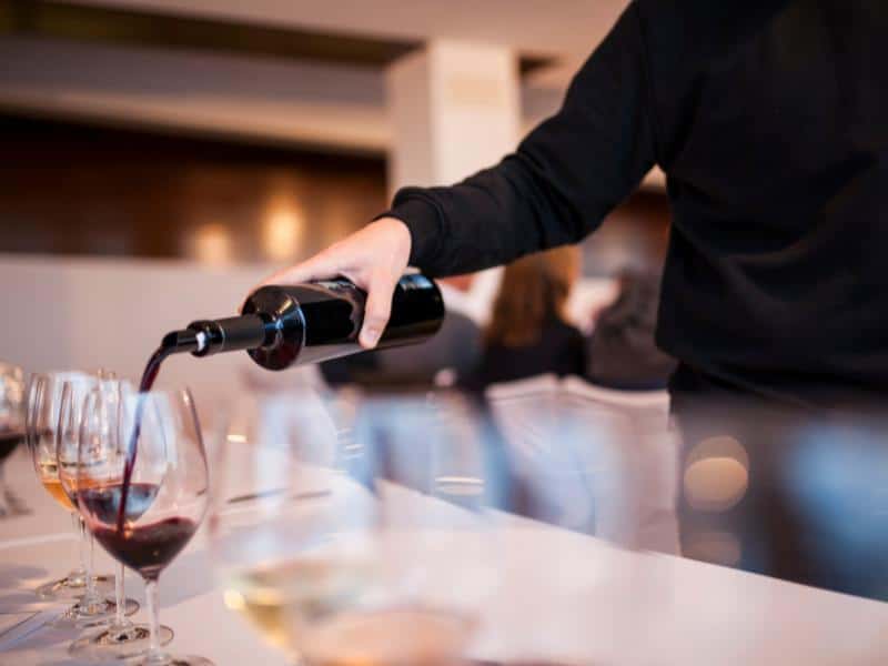 Waiter pouring some wine for a wine tasting in one of Ericeira's excellent wineries.