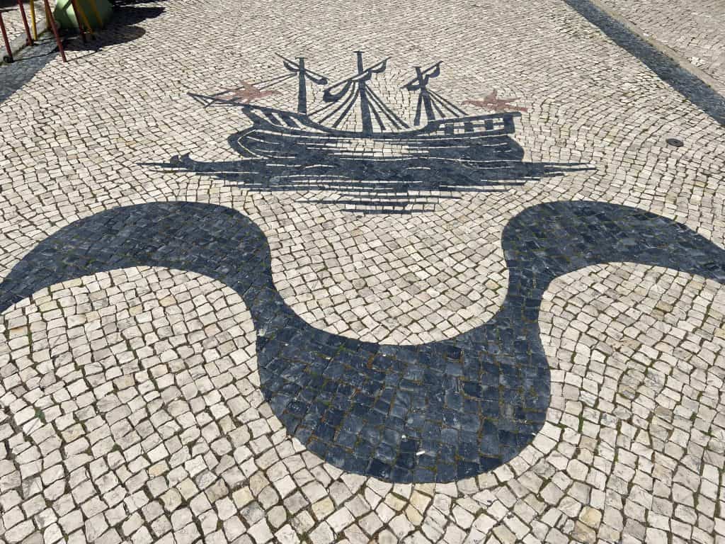The boat in the mosaic cobblestone roads in downtown Ericeira village. Close to many hotels in Ericeira
