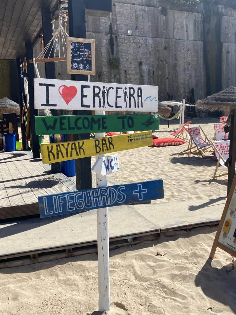 Painted sign posts in front Kayak bar, down on Praia do Pescador in downtown Ericeira.