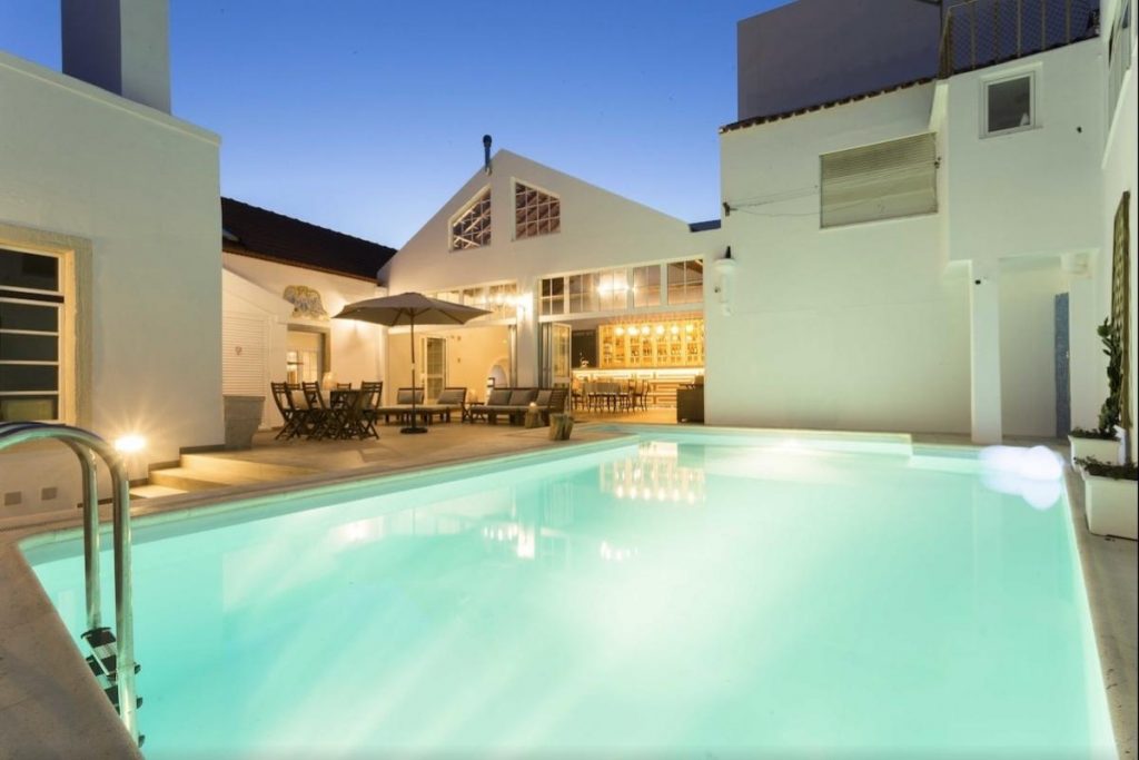 The pool lit up at night at Ericeira Soul Guesthouse one of the best boutique hotels Ericeira.