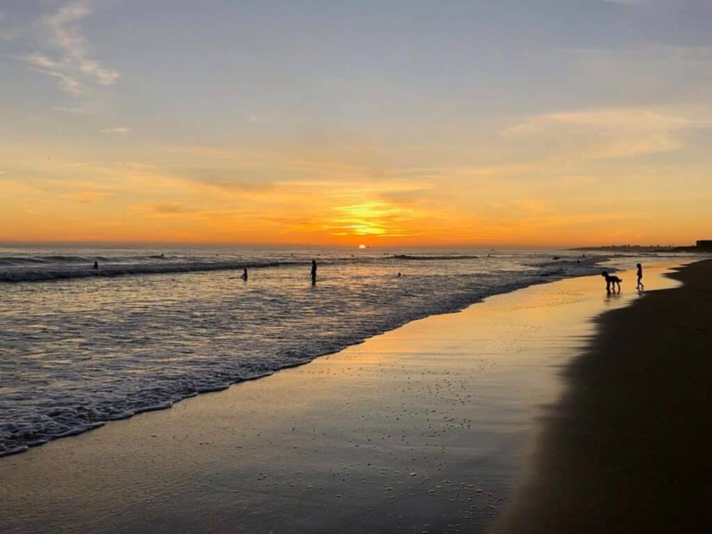  Carcavelos beach at sunset with few people enjoying the low tide. It is only 25 minutes away from downtown Lisbon.