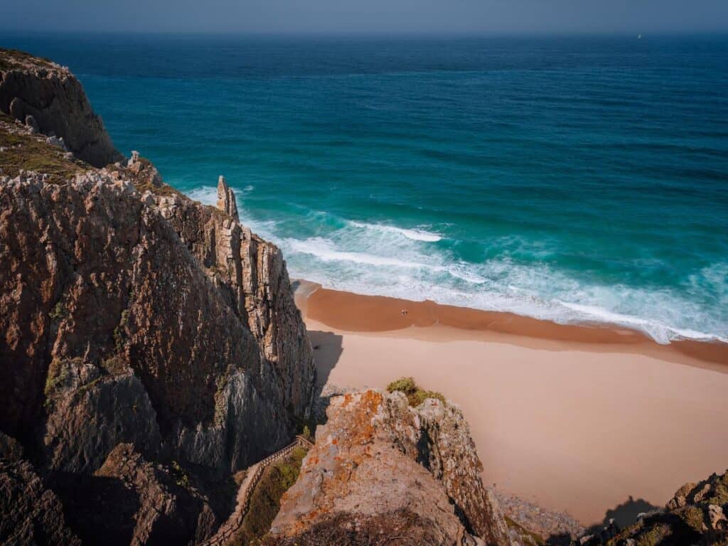 Praia Grande has gorgeous contrasting turquoise waters and the golden beach stretching out from the rocky cliffs to the left.