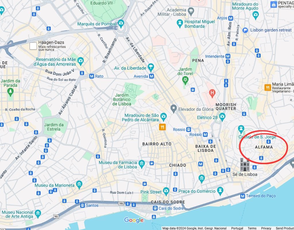A map of Lisbon, Portugal, highlighting various landmarks and neighborhoods. The Alfama area is circled in red, located near the bottom right. 