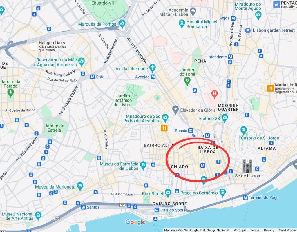 A map of Lisbon, Portugal, highlighting various landmarks and neighborhoods. The Baixa-Chiado area is circled in red, located near the bottom center. 