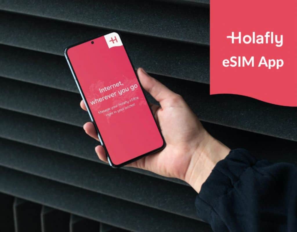 A person holds a smartphone displaying the red "Holafly eSIM App" interface, which offers a service for managing mobile eSIMs on the go.